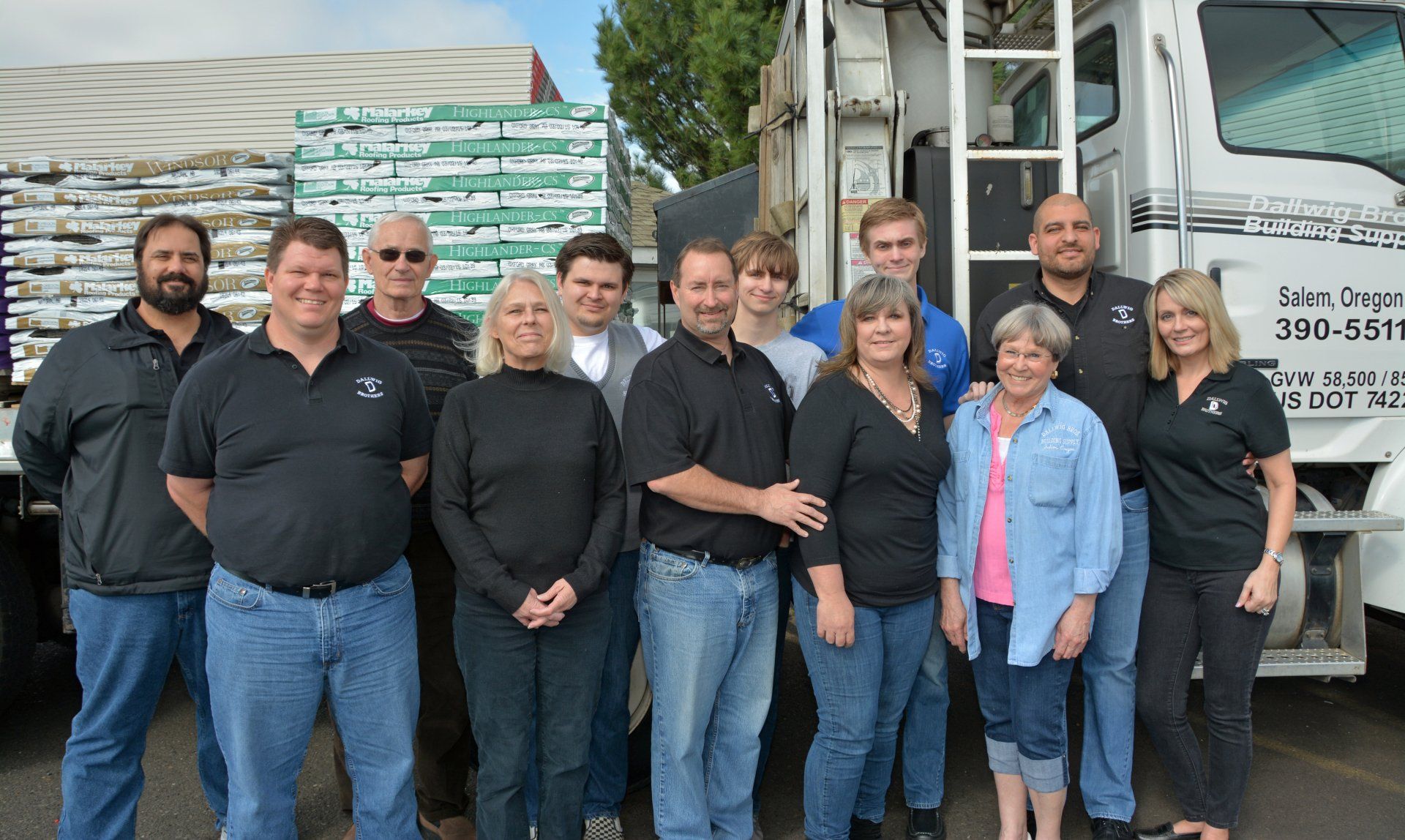 A group photo of the entire staff of Dallwig Brothers with there Truck behind them.